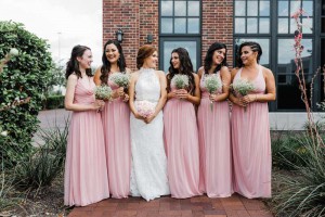 bride with bridesmaids outdoors at The Ark in Katy