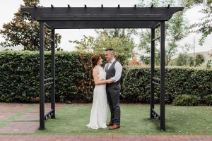 photo of bride and groom outdoors under a pergola at The Ark in Katy