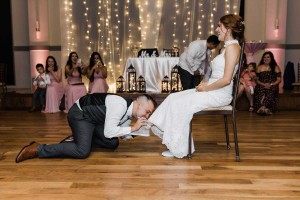 photo of the groom removing the bride's garter
