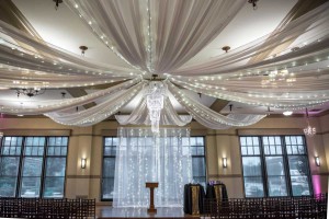 Sweeping fabric and lights chandelier over the setting for a wedding ceremony at The Ark in Katy